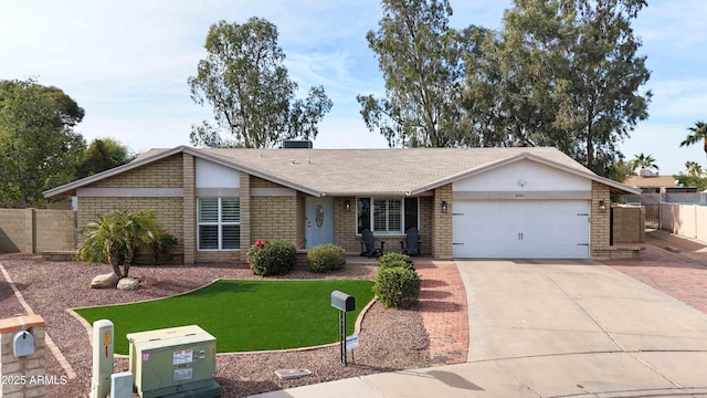 single story home with a garage and a front yard