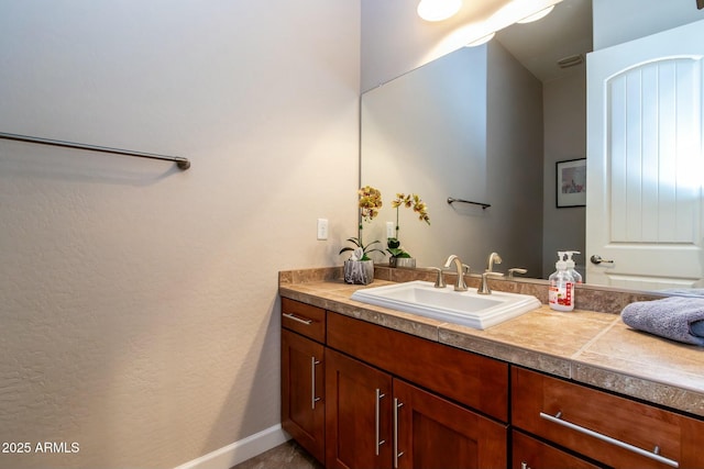 bathroom featuring vanity and baseboards