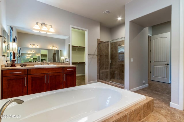 full bathroom with a stall shower, visible vents, baseboards, vanity, and a bath