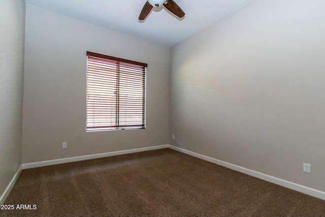 empty room with lofted ceiling, ceiling fan, baseboards, and carpet flooring