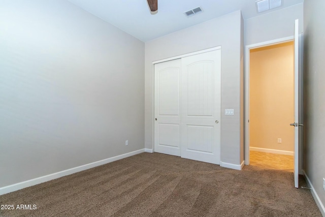 unfurnished bedroom with baseboards, visible vents, and a closet