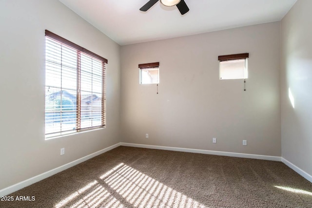 unfurnished room with carpet, a ceiling fan, and baseboards