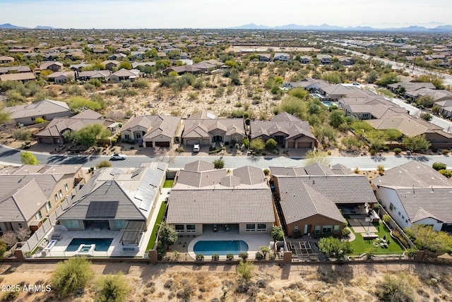 drone / aerial view featuring a residential view and a mountain view