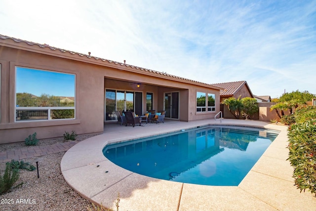 view of swimming pool featuring fence, a fenced in pool, and a patio