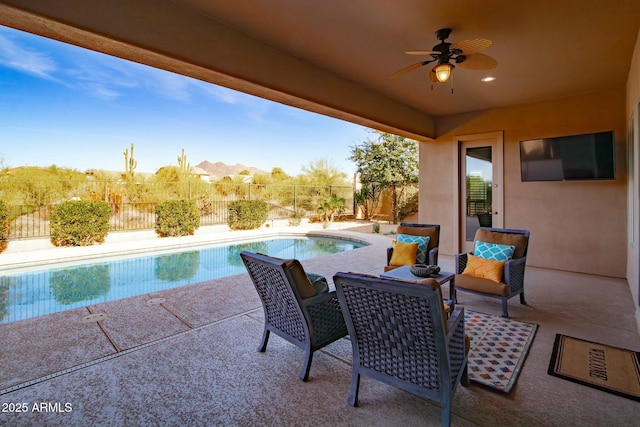 view of patio / terrace with a fenced in pool, a fenced backyard, and a ceiling fan