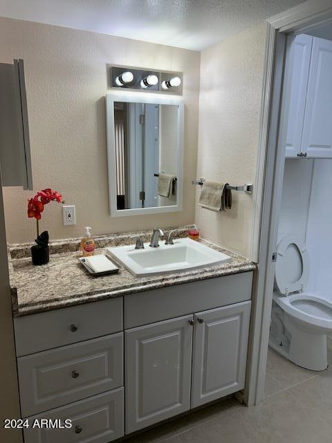 bathroom with tile patterned floors, vanity, and toilet