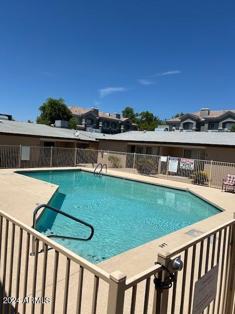 pool featuring a patio area and fence