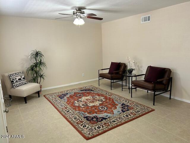 sitting room featuring ceiling fan, visible vents, and baseboards