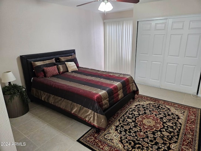 bedroom with ceiling fan, a closet, and light tile patterned floors