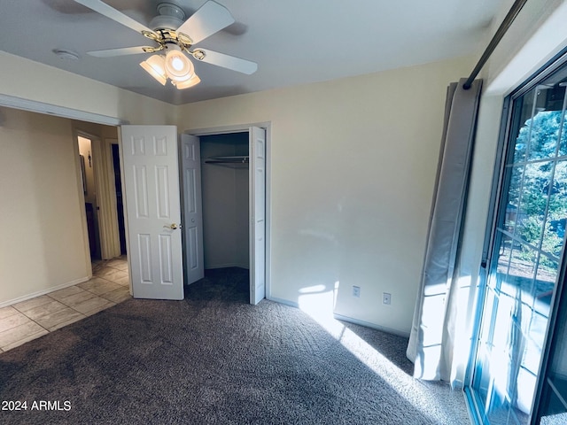 unfurnished bedroom with carpet flooring, a ceiling fan, and a closet