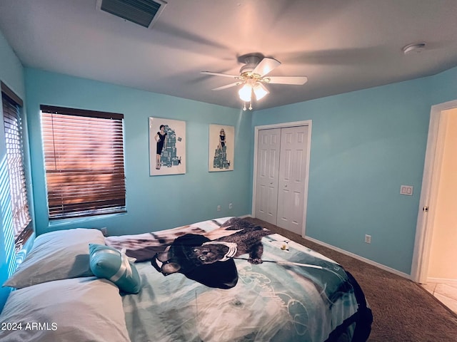 bedroom with a ceiling fan, baseboards, visible vents, a closet, and carpet flooring