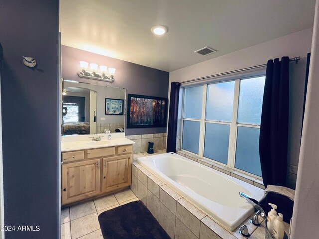 full bathroom featuring tile patterned flooring, visible vents, vanity, and a garden tub