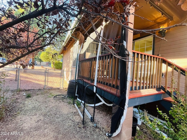 wooden terrace with fence and a gate