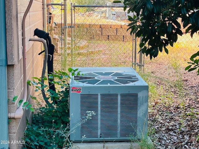 exterior details with central air condition unit and fence