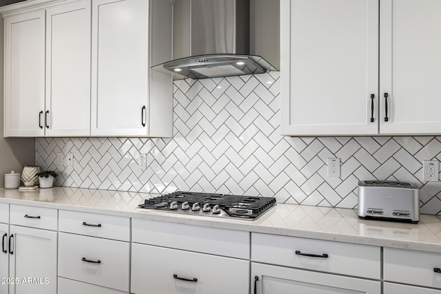 25725 S 230th St, Queen Creek, AZ 85142 - kitchen featuring wall chimney exhaust hood, decorative backsplash, stainless steel gas stovetop, and white cabinetry