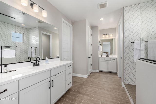 25725 S 230th St, Queen Creek, AZ 85142 - full bath featuring a sink, baseboards, wood finish floors, two vanities, and a walk in shower