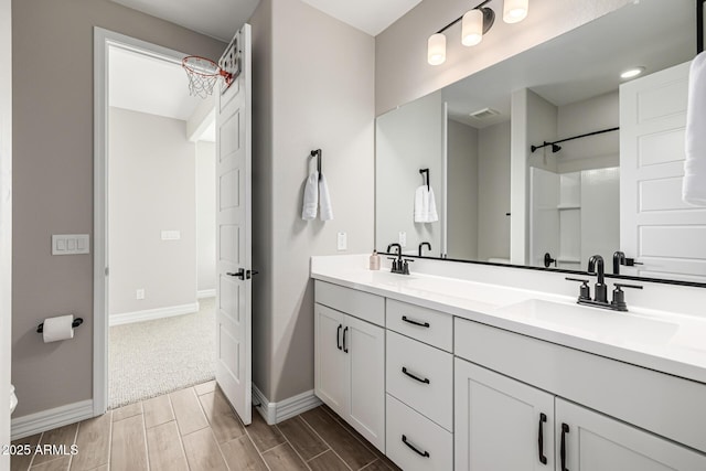 25725 S 230th St, Queen Creek, AZ 85142 - bathroom featuring wood tiled floor, baseboards, a sink, and double vanity