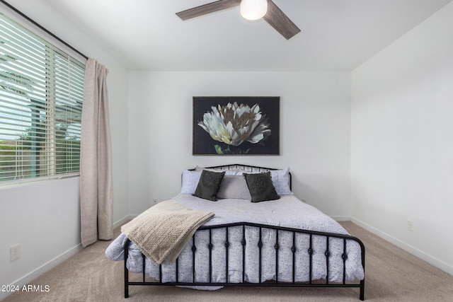 carpeted bedroom with multiple windows and ceiling fan