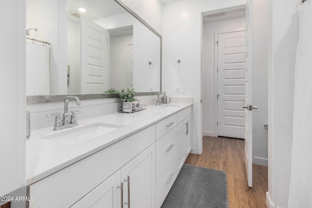 bathroom featuring vanity and hardwood / wood-style floors