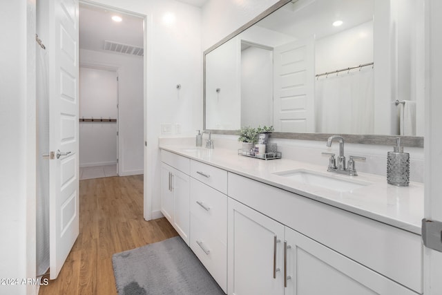 bathroom featuring vanity and hardwood / wood-style flooring