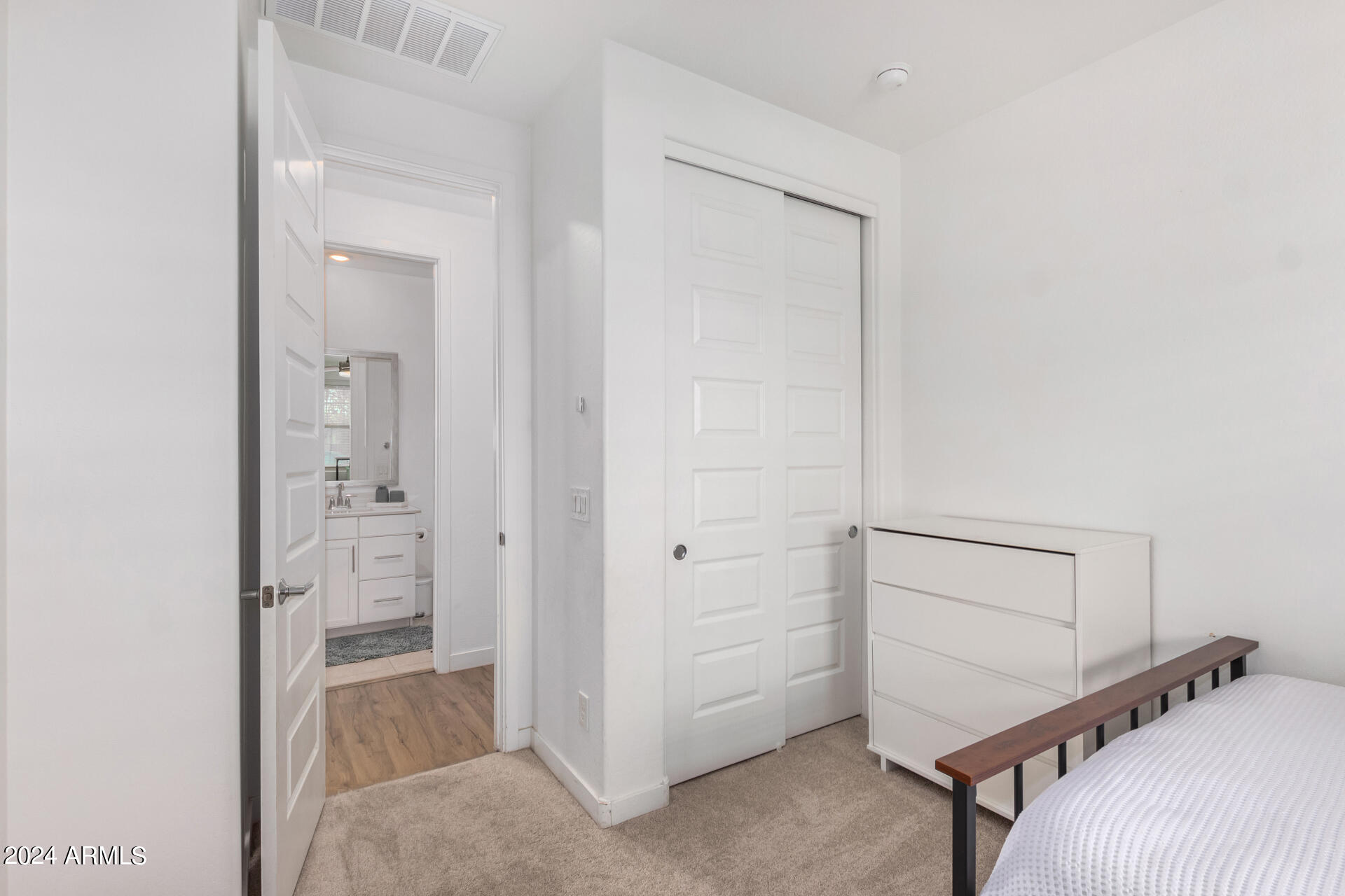 bedroom featuring light carpet and a closet