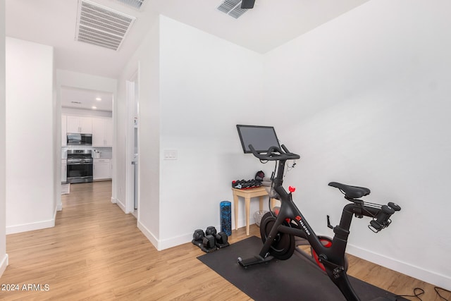 workout area featuring light hardwood / wood-style floors