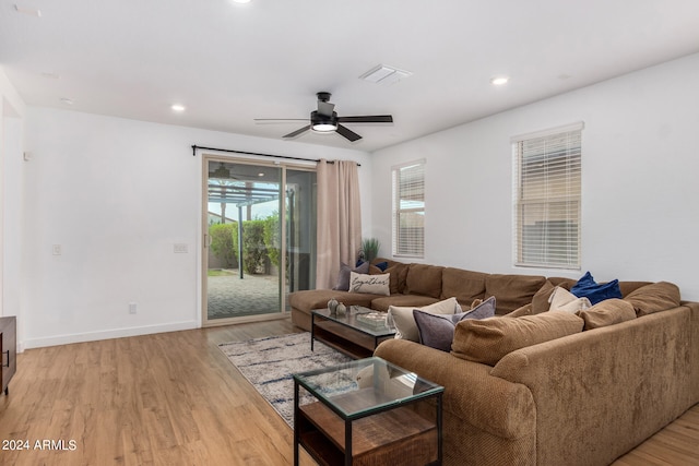 living room featuring ceiling fan and light wood-type flooring