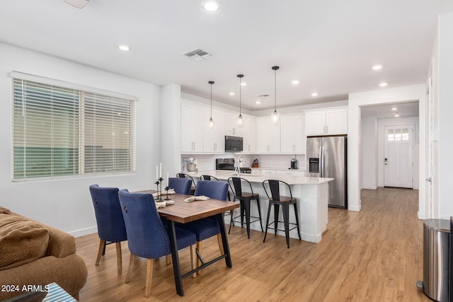 dining space featuring light hardwood / wood-style flooring