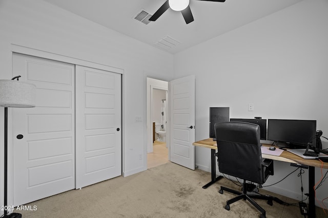 office space featuring light colored carpet and ceiling fan