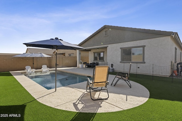 view of pool with a lawn and a patio area