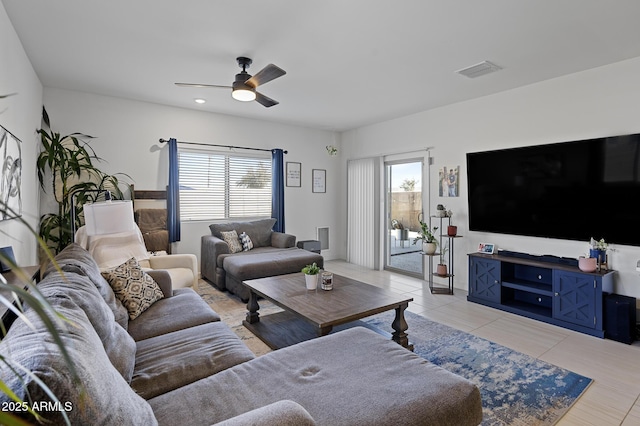 tiled living room featuring plenty of natural light and ceiling fan