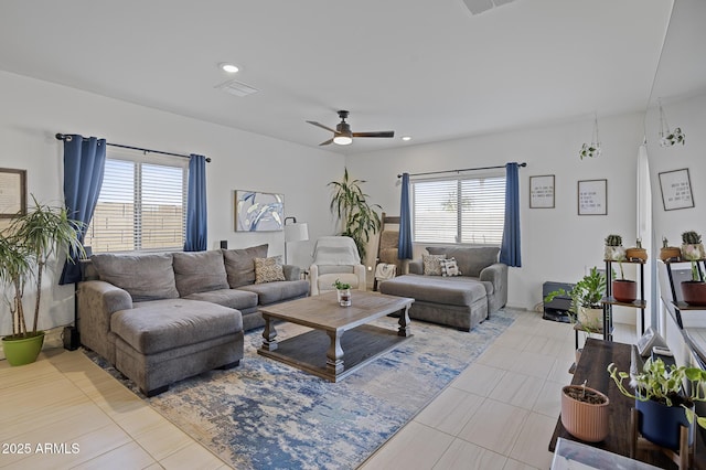 living room featuring ceiling fan and a healthy amount of sunlight