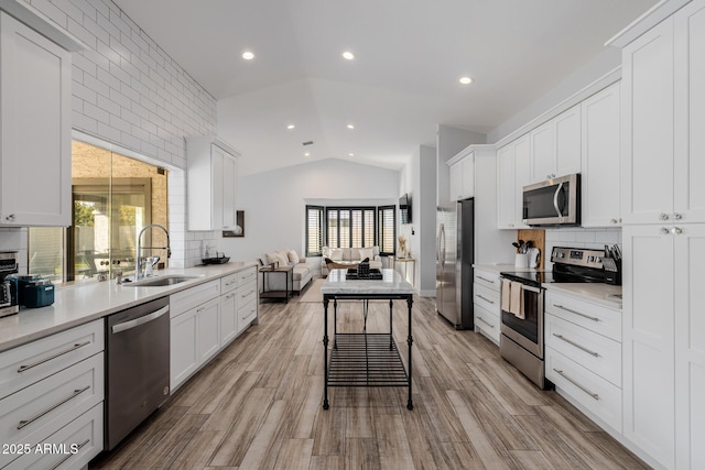 kitchen featuring sink, white cabinets, and appliances with stainless steel finishes