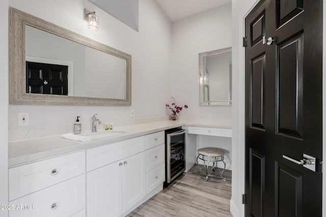 bathroom featuring vanity, wood-type flooring, and wine cooler