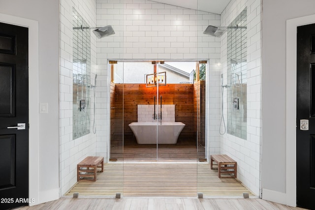 bathroom featuring shower with separate bathtub and vaulted ceiling