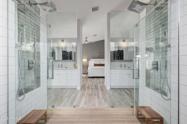 bathroom featuring a shower with door, vanity, hardwood / wood-style floors, and ceiling fan