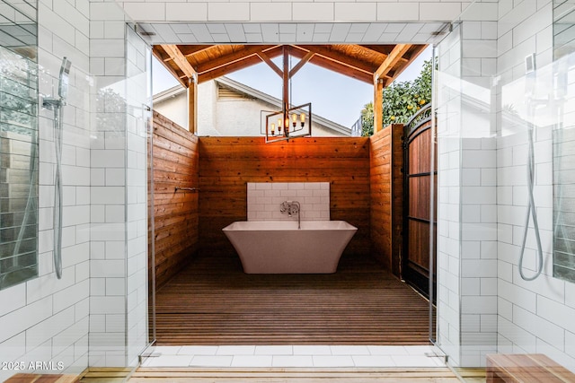 bathroom with lofted ceiling and separate shower and tub