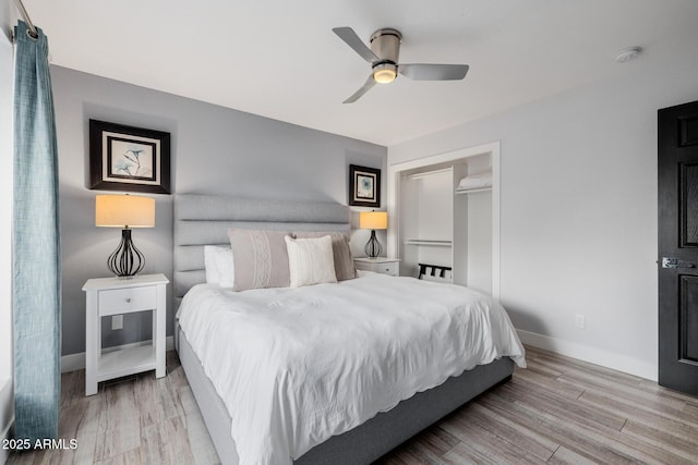 bedroom with ceiling fan, light wood-type flooring, and a closet