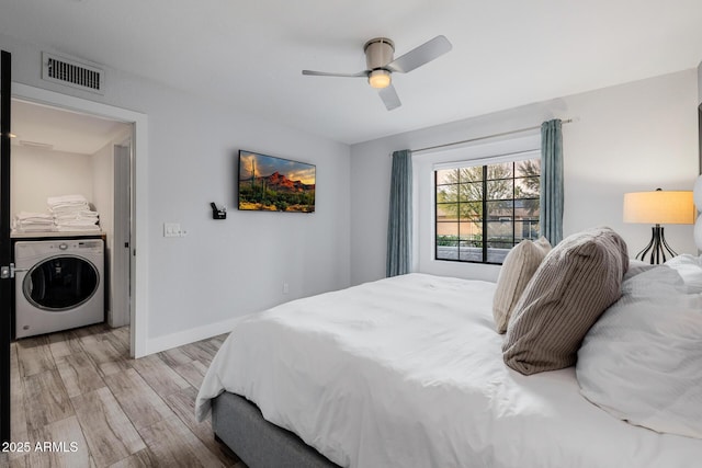 bedroom with washer / clothes dryer, ceiling fan, and light hardwood / wood-style flooring