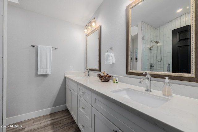 bathroom featuring vanity, hardwood / wood-style floors, and a shower with shower door