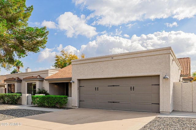 pueblo-style house featuring a garage