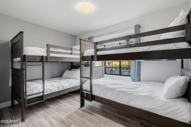 bedroom with wood-type flooring