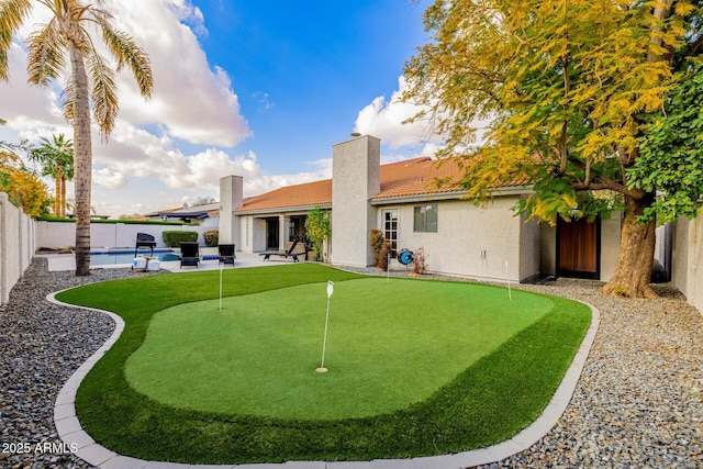 exterior space with a fenced in pool and a patio area