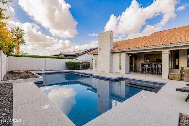 view of pool featuring a bar and a patio area