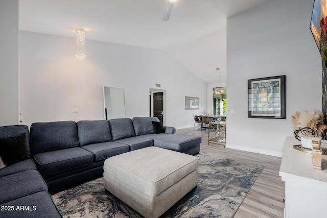 living room featuring wood-type flooring and high vaulted ceiling