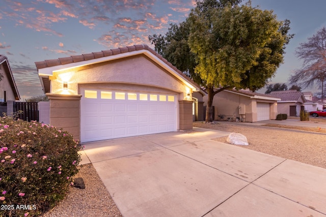 view of front of property featuring a garage and an outdoor structure