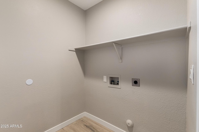 washroom featuring hardwood / wood-style flooring, hookup for a gas dryer, hookup for a washing machine, and electric dryer hookup