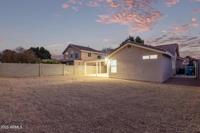 view of back house at dusk