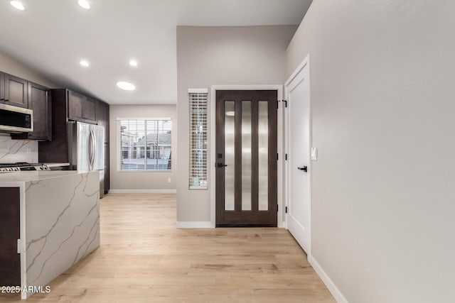 entryway with light hardwood / wood-style floors