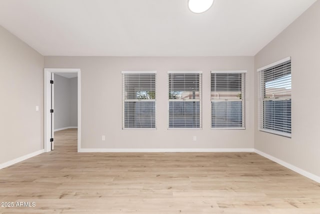 spare room with light hardwood / wood-style floors